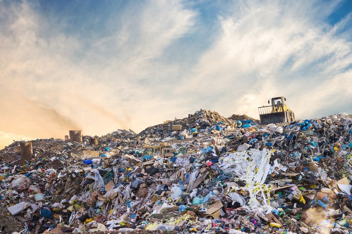 a landfill with trash and a dump truck on it