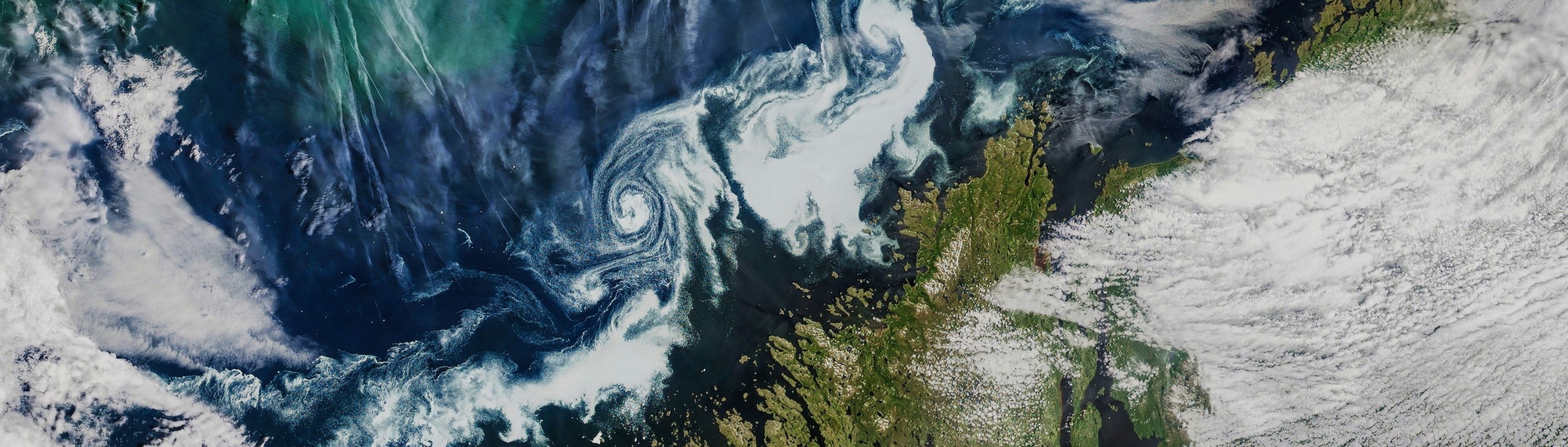 Closeup satellite view of Earth with land and clouds