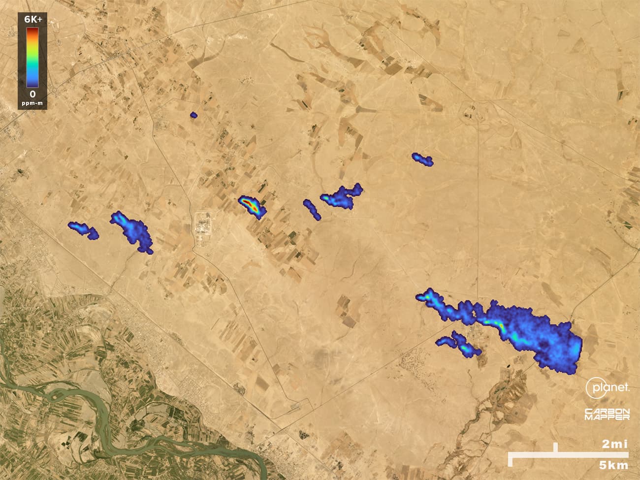 On the background of a satellite image, methane plumes can be seen across a stretch of Syria. They are colored with a gradient that matches the methane emissions intensity of each plume's emissions.